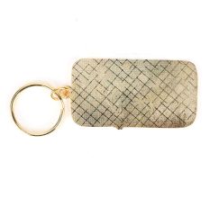 Brass White Lily Key Chain On Orange Background