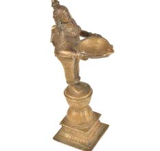 Brass Lady Holding A Diya In Her Hand And Is On A Raised Platform