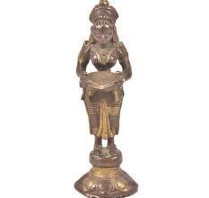 Bronze Lady Holding A Diya In Her Hand Is On A Raised Platform