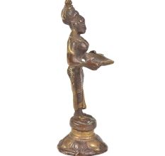 Bronze Lady Holding A Diya In Her Hand Is On A Raised Platform