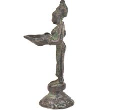 Bronze Lady Holding A Diya In Her Hand Is On A Raised Platform With Patina