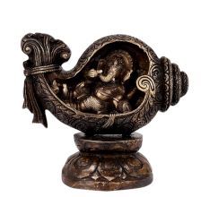 Brass Ganesha Sitting in a Conch In Black Finish