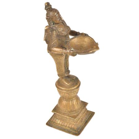 Brass Lady Holding A Diya In Her Hand And Is On A Raised Platform