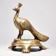 Brass Peacock Figurine on Table
